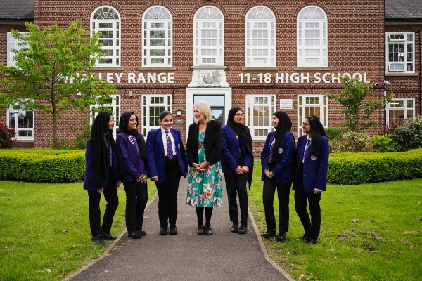 Mrs J. Fahey, Academy Headteacher from Sep 2020 - Aug 2024, pictured with students outside Whalley Range 11-18 High School