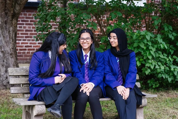 Students sitting on a bench in the quads