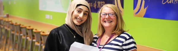 Student celebrates her results with a teacher on Sixth Form Results Day 2023