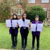 Students show off their iDEA Award certificates, in September 2024