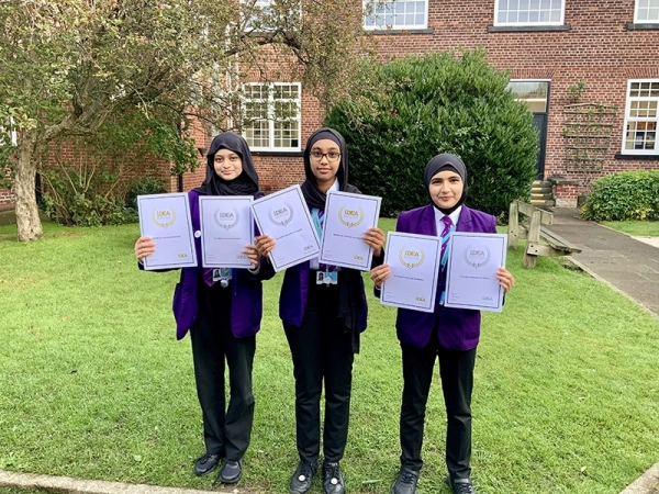 Students show off their iDEA Award certificates, in September 2024