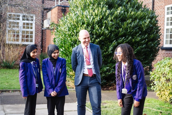 Mr M. Lea, Academy Headteacher, with students on the school grounds