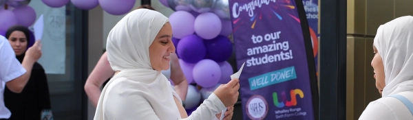 A student celebrates their results on Sixth Form Results Day 2025
