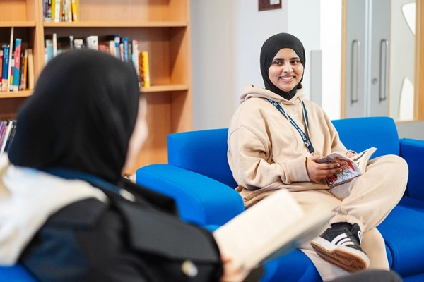 Sixth Form students talking to each other in the library